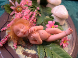 baby fairy sleeping in garden patch