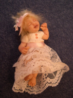 baby fairy doll in a christening outfit