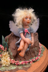 baby angel doll in a garden patch