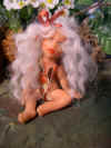 fairy doll in fairy garden patch