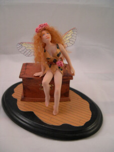 Fairy Temptress sitting on a dream box with cicada wings